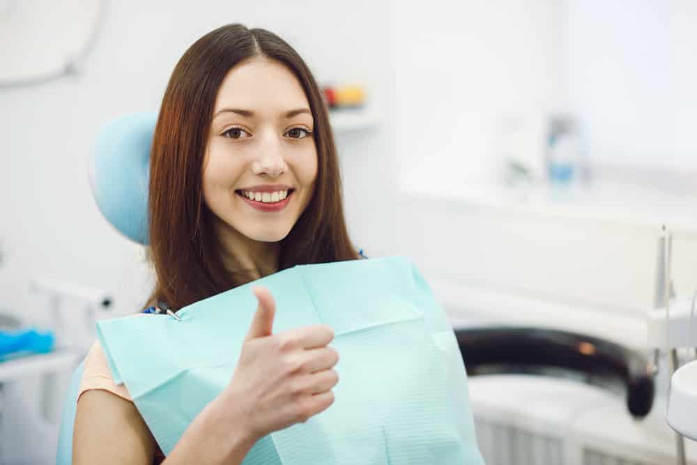 Girl Smiling in Dental Chair