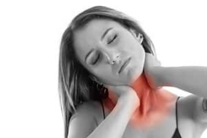 Woman holding neck that is in pain.