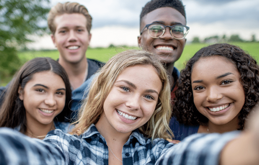 Selfie of five teens who had teeth whitening.