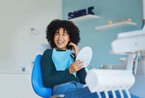 Woman Smiling while visiting the Best Dentist for Implants near Franklin MI