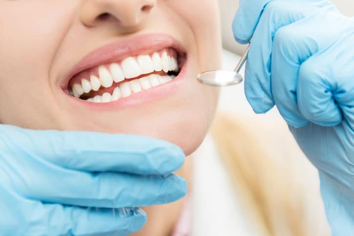 Horizontal close-up image of woman having dental examination.