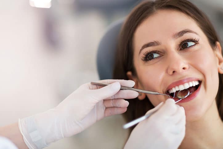 Woman Smiling At Dentist