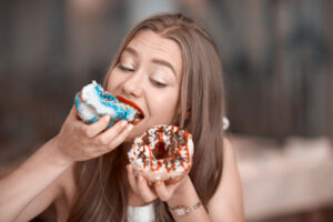 Woman Eating Donuts