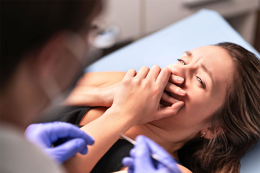 Woman Covering Mouth at Dental Visit