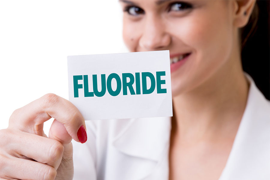 Woman holding Flouride Sign