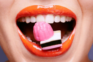 Closeup of woman's mouth with Candy in it