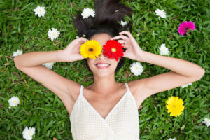 Woman Laying in Flowers Smiling