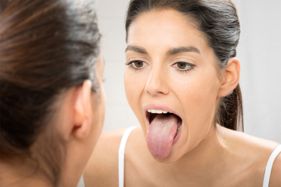 Woman with mouth open in mirror