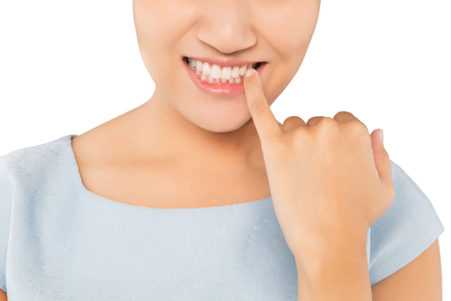 Woman pointing at teeth