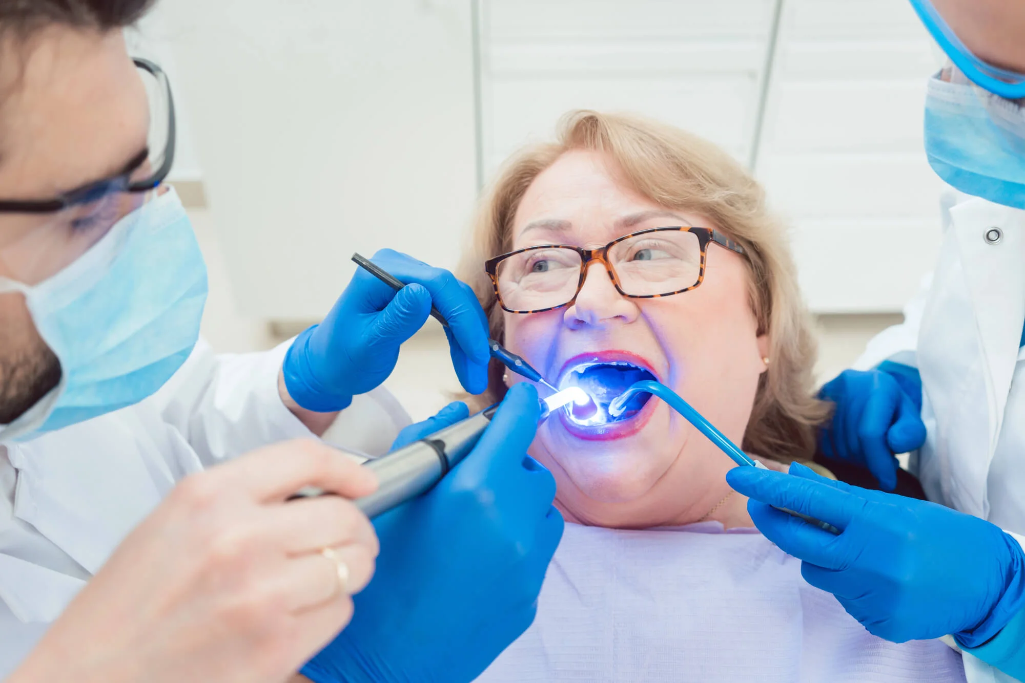 Dentist in Royal Oak, MI curing dental crowns with UV light during restorative treatment.