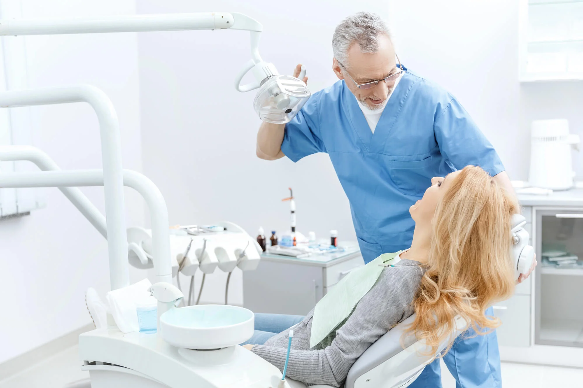 Friendly dentist in Royal Oak, MI consulting with patient at a trusted dental office.