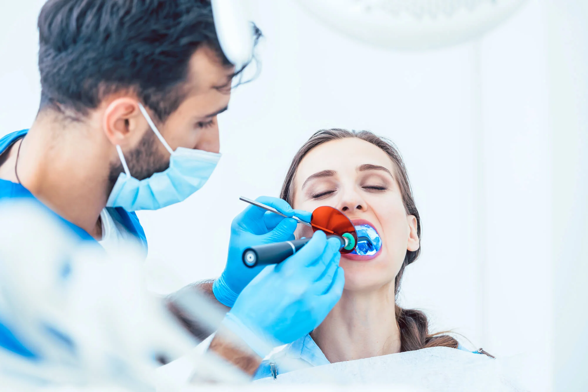A dentist Birmingham, MI doing procedure on female patient.