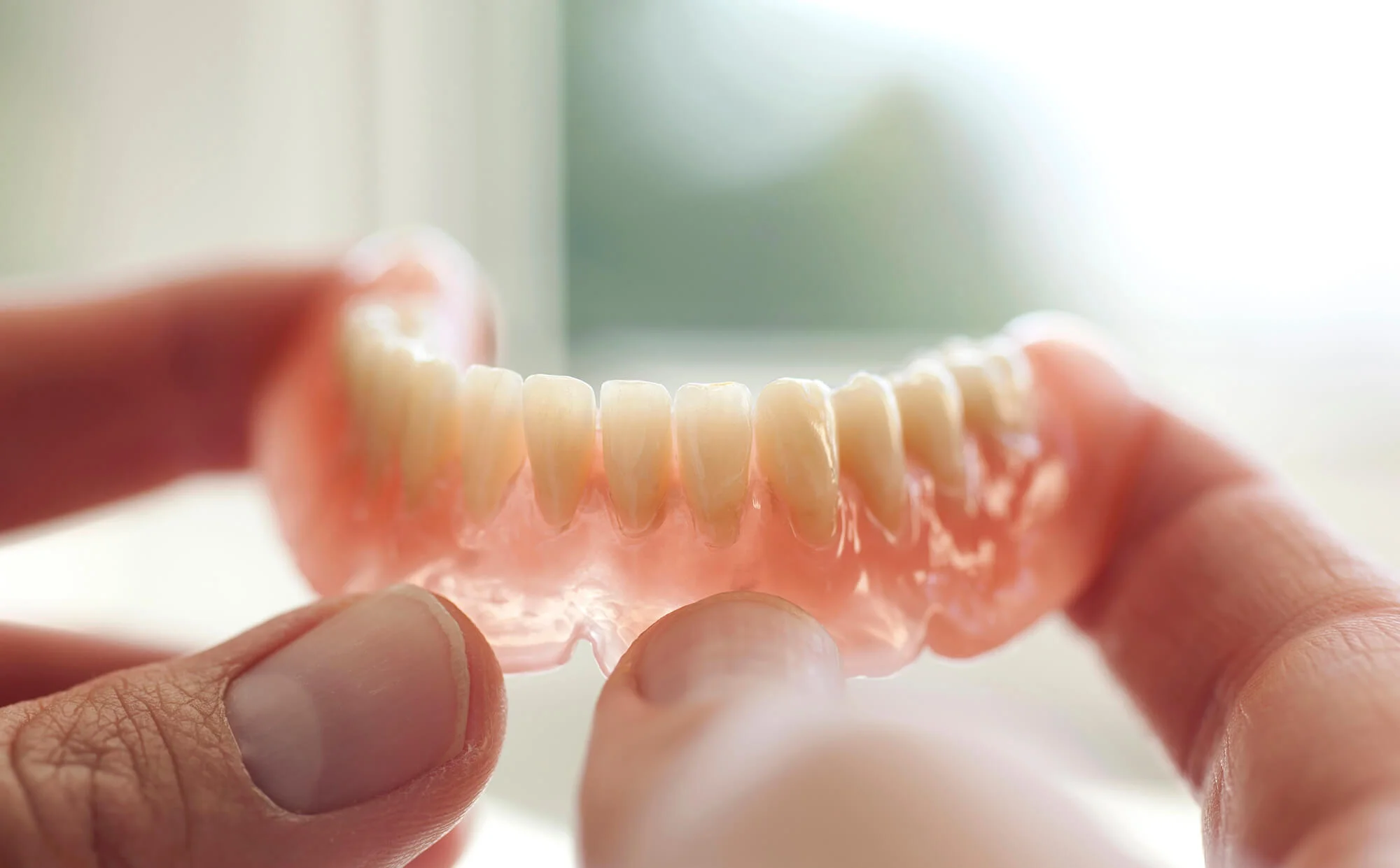 Dental technician crafting Birmingham dentures and implants.