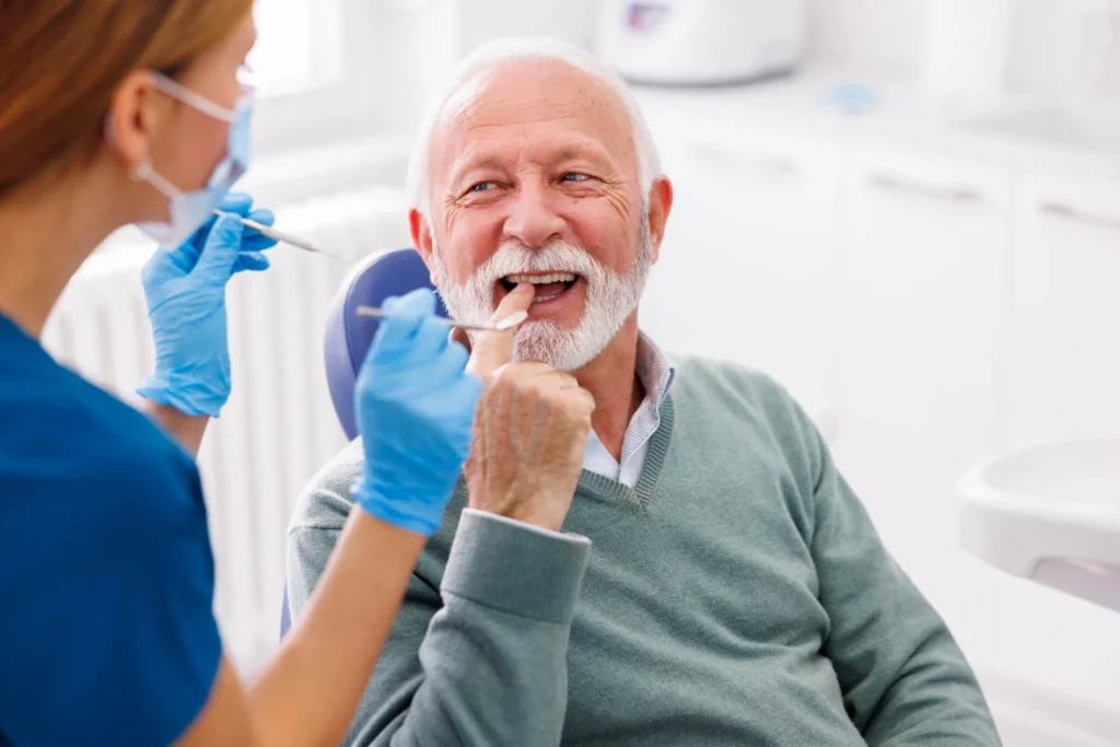 Dentist doing dental checkup on a patient for Birmingham dentures and implants.