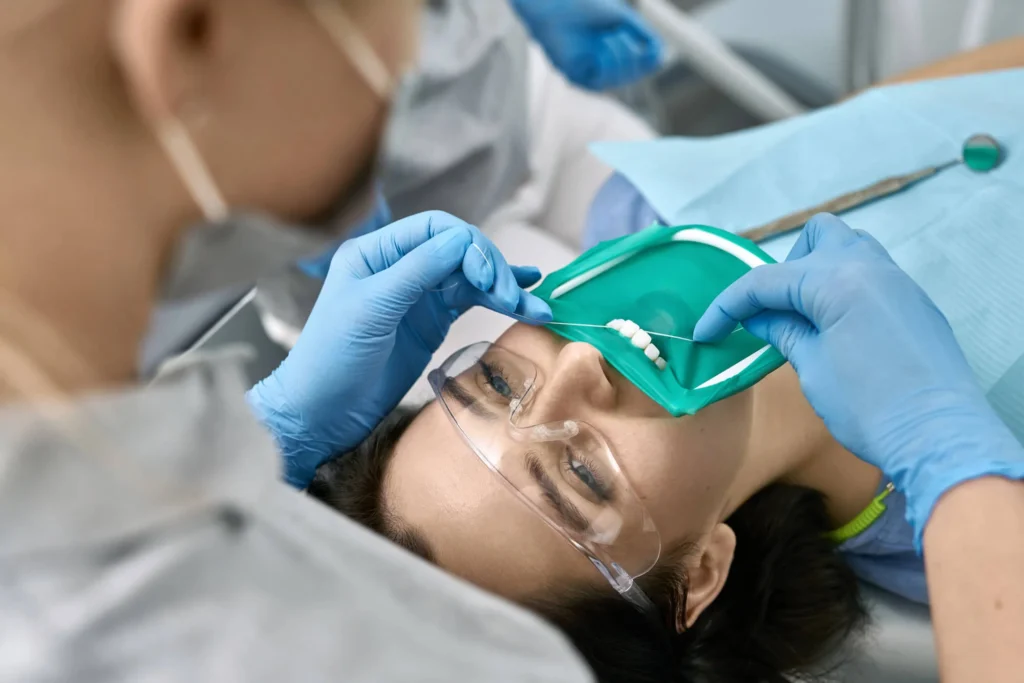 Patient receiving professional teeth cleaning in Birmingham, MI.