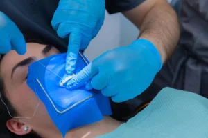 Patient under teeth cleaning in Birmingham, MI.