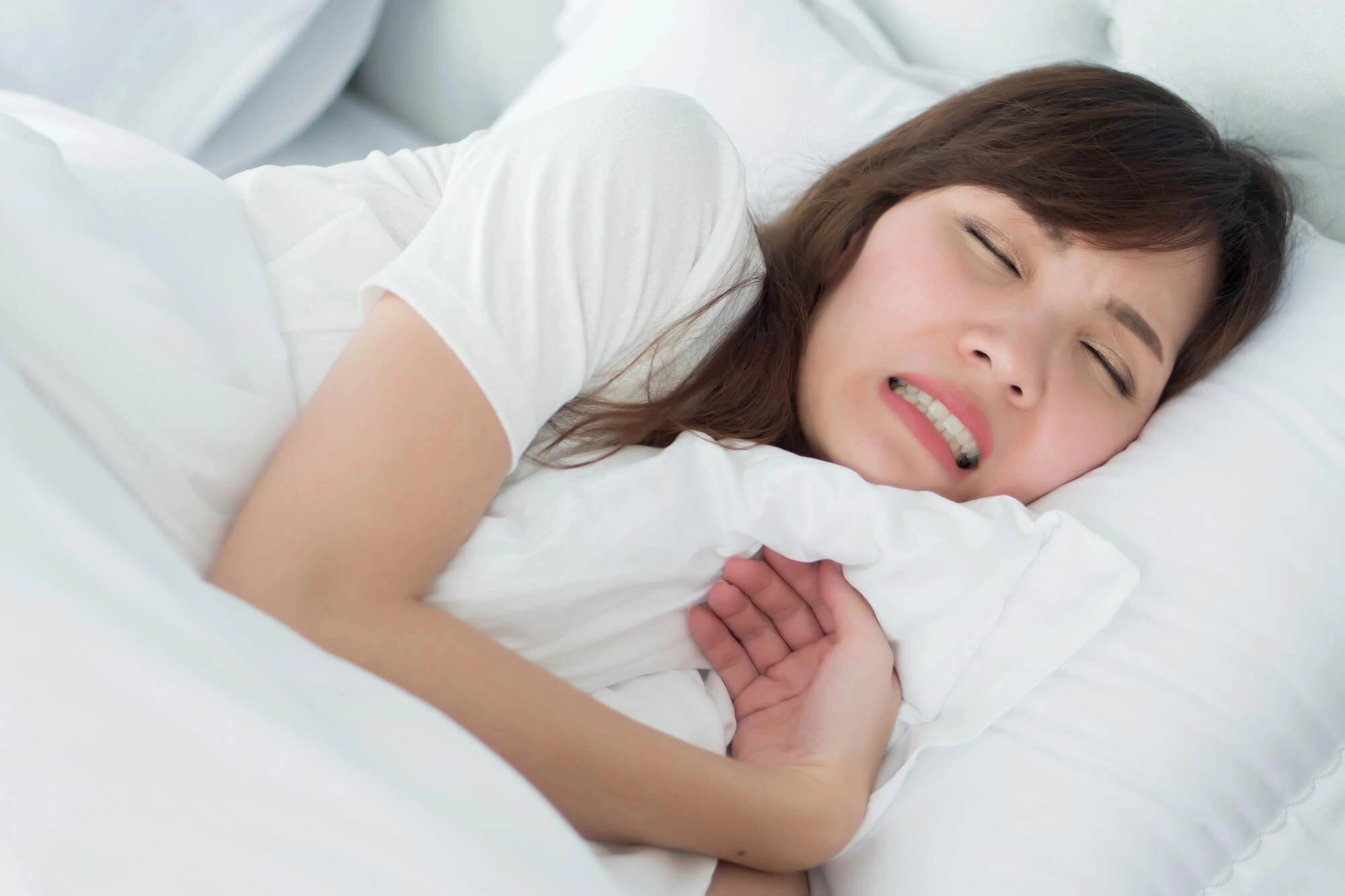 Stressed woman with grinding teeth needing a Dentist in Birmingham MI