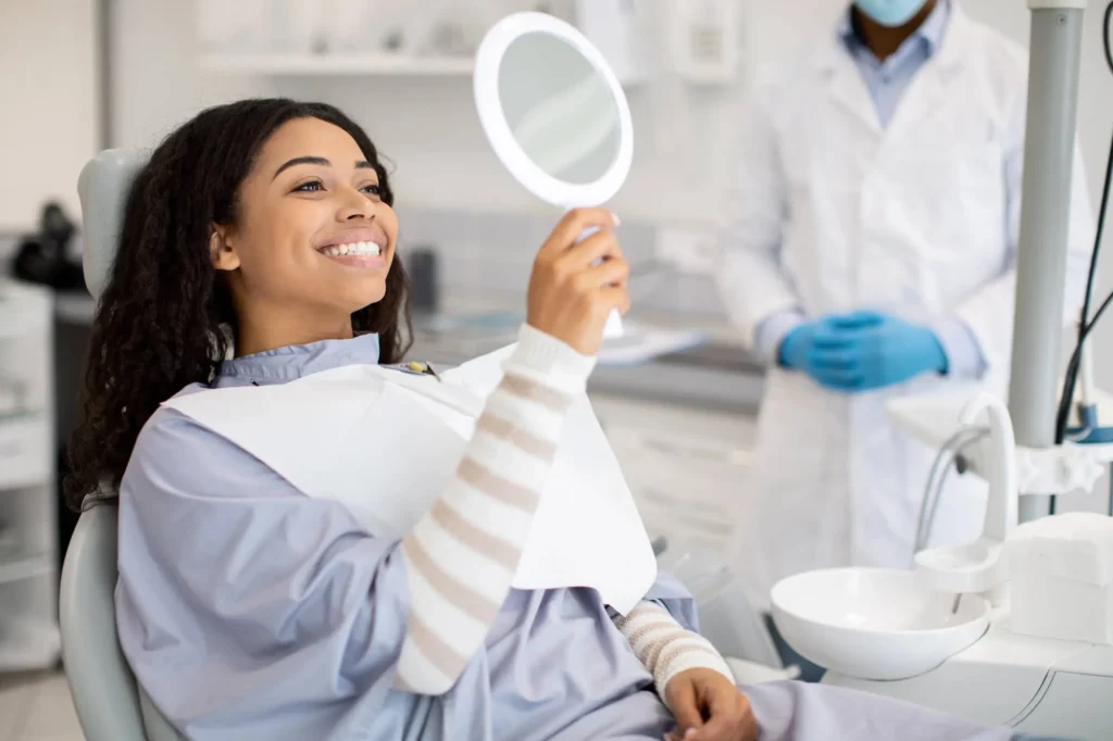 Happy patient after visiting a dentist in Royal Oak MI